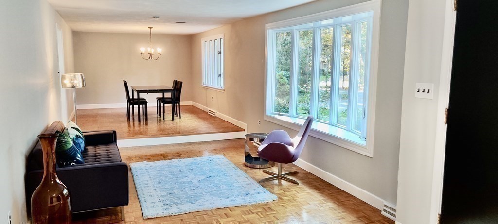 123 Lincoln Road Wayland, MA 01778 - Photo 12 of 26 a living room with furniture rug and a floor to ceiling window