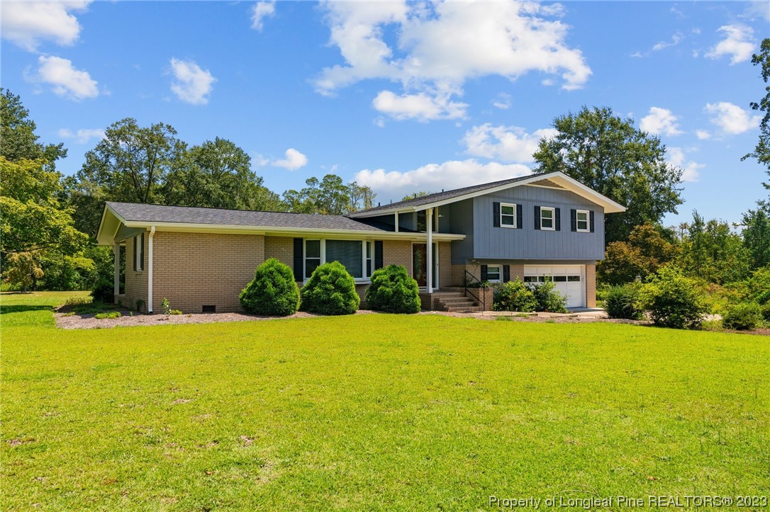 1812 Bainbridge Road Stedman, NC 28391 - Photo 1 of 30 a front view of a house with yard and green space