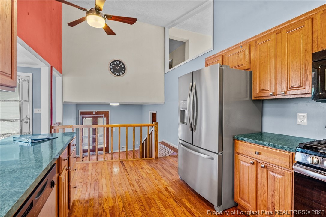 1812 Bainbridge Road Stedman, NC 28391 - Photo 17 of 30 a kitchen with stainless steel appliances granite countertop a refrigerator a stove and a sink with cabinets