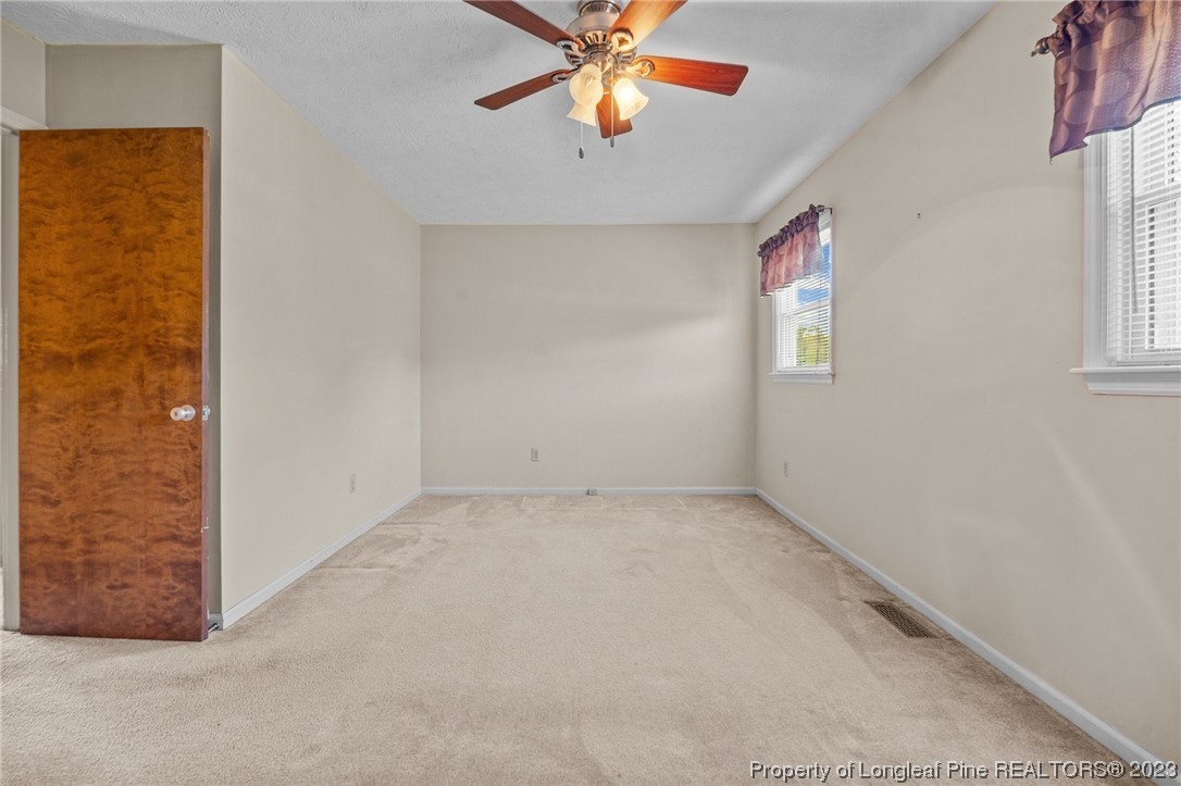 1812 Bainbridge Road Stedman, NC 28391 - Photo 25 of 30 an empty room with windows and fan