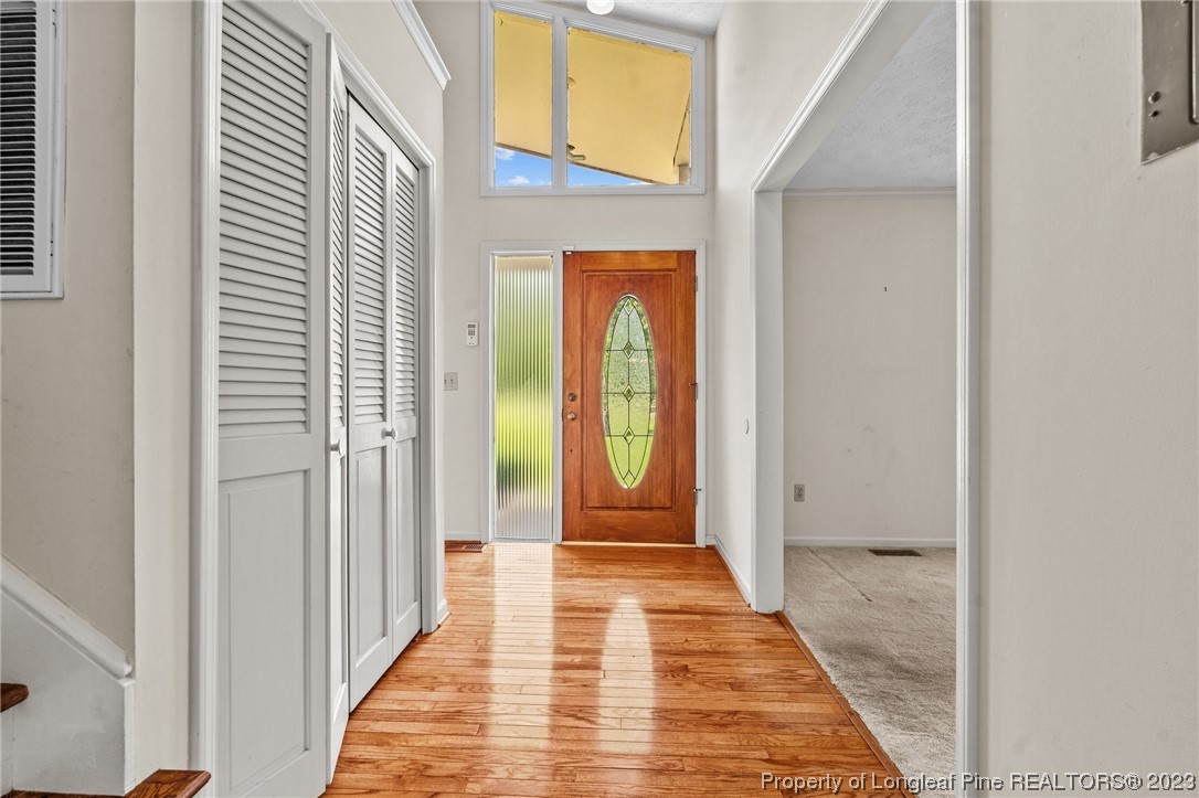 1812 Bainbridge Road Stedman, NC 28391 - Photo 3 of 30 a view of a hallway with wooden floor and a bathroom
