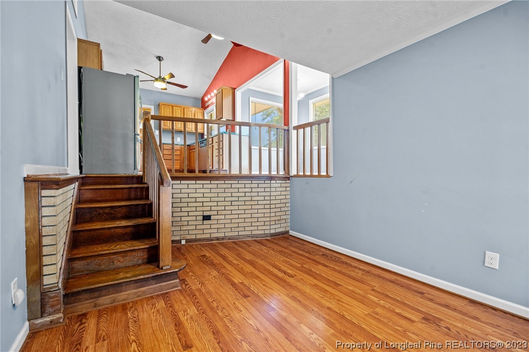 1812 Bainbridge Road Stedman, NC 28391 - Photo 4 of 30 a view of empty room with stairs and wooden floor