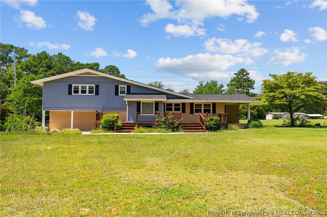 1812 Bainbridge Road Stedman, NC 28391 - Photo 8 of 30 a front view of a house with a garden