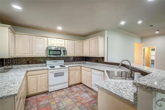 a kitchen with a sink stove and cabinets