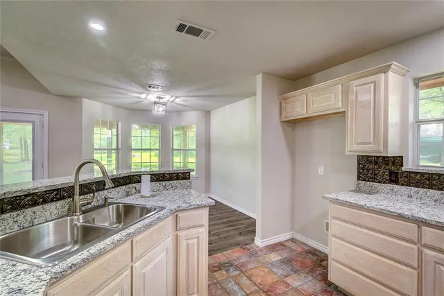 a kitchen with a sink cabinets and window