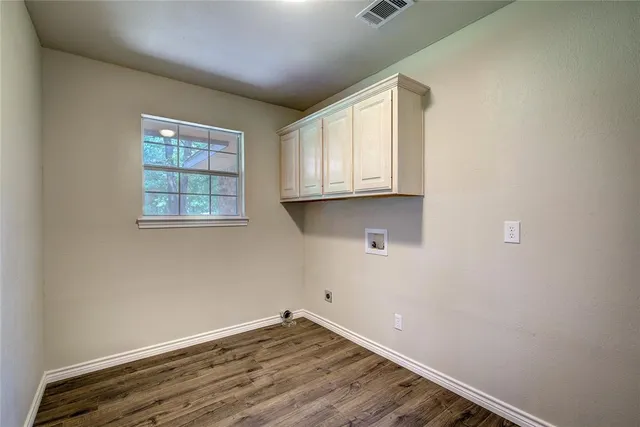 a room with wooden floor and window