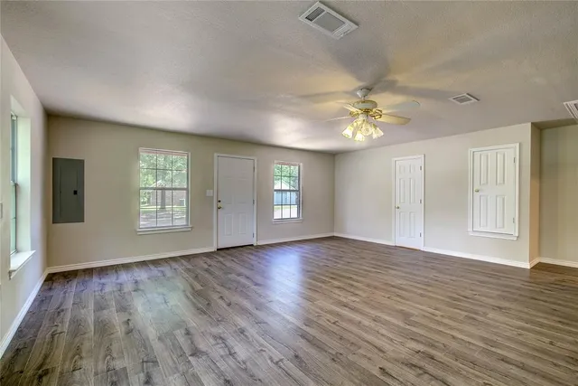 wooden floor in an empty room with a window