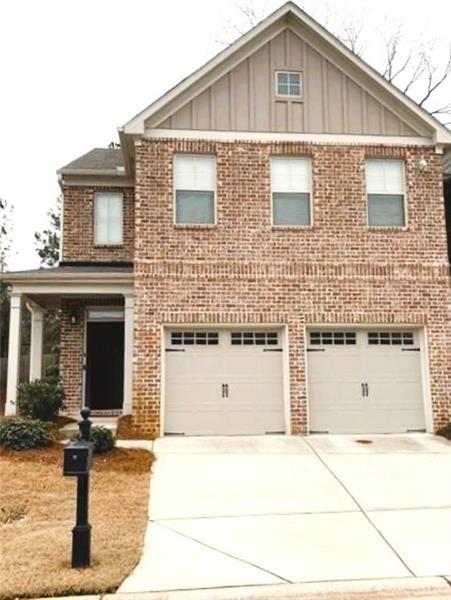a front view of a house with garage