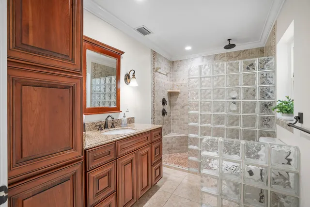 a bathroom with a double vanity sink a mirror and a shower