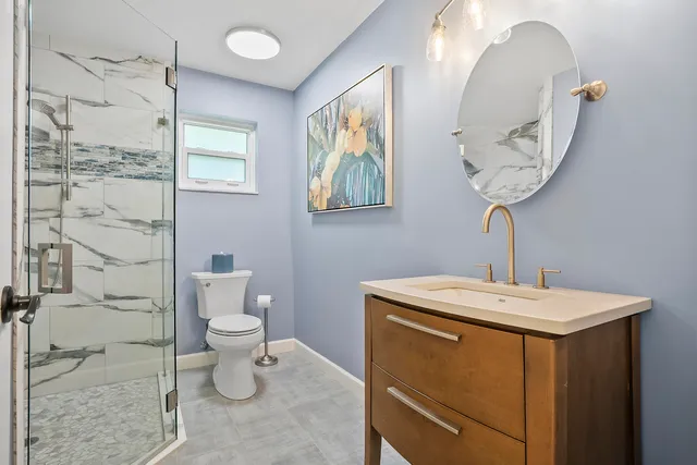 a bathroom with a sink a toilet and mirror