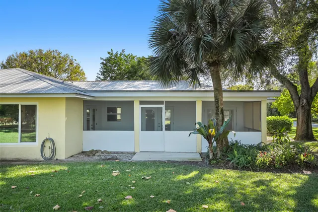 a front view of house with a garden