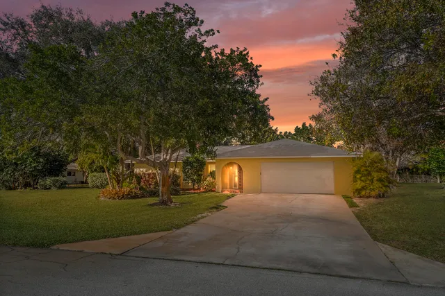 a view of backyard of house with trees