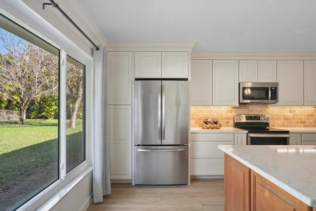 a kitchen with a refrigerator a stove and a sink