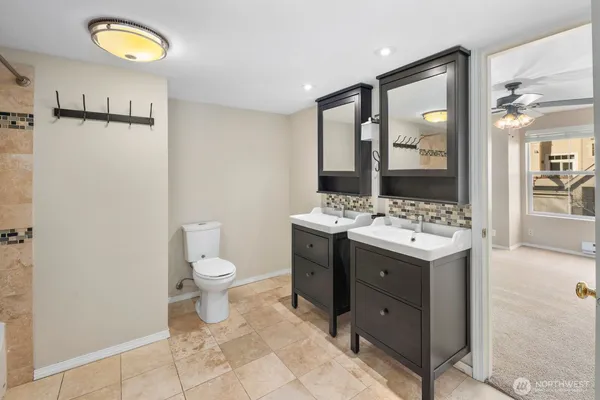 a bathroom with a toilet sink and mirror
