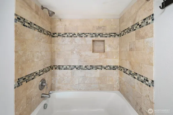 a bathroom with a shower and a bath tub