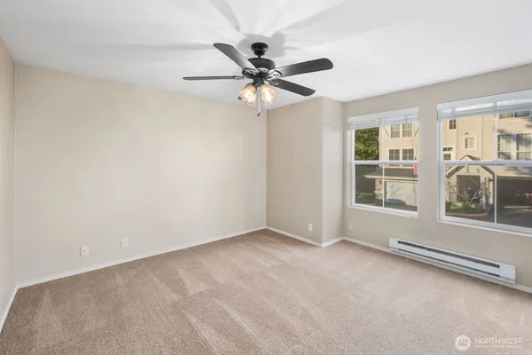 a view of a livingroom with a ceiling fan and window