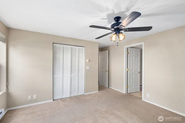 a view of a livingroom with a ceiling fan and window