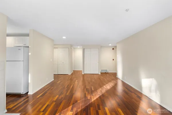 a view of an empty room and wooden floor