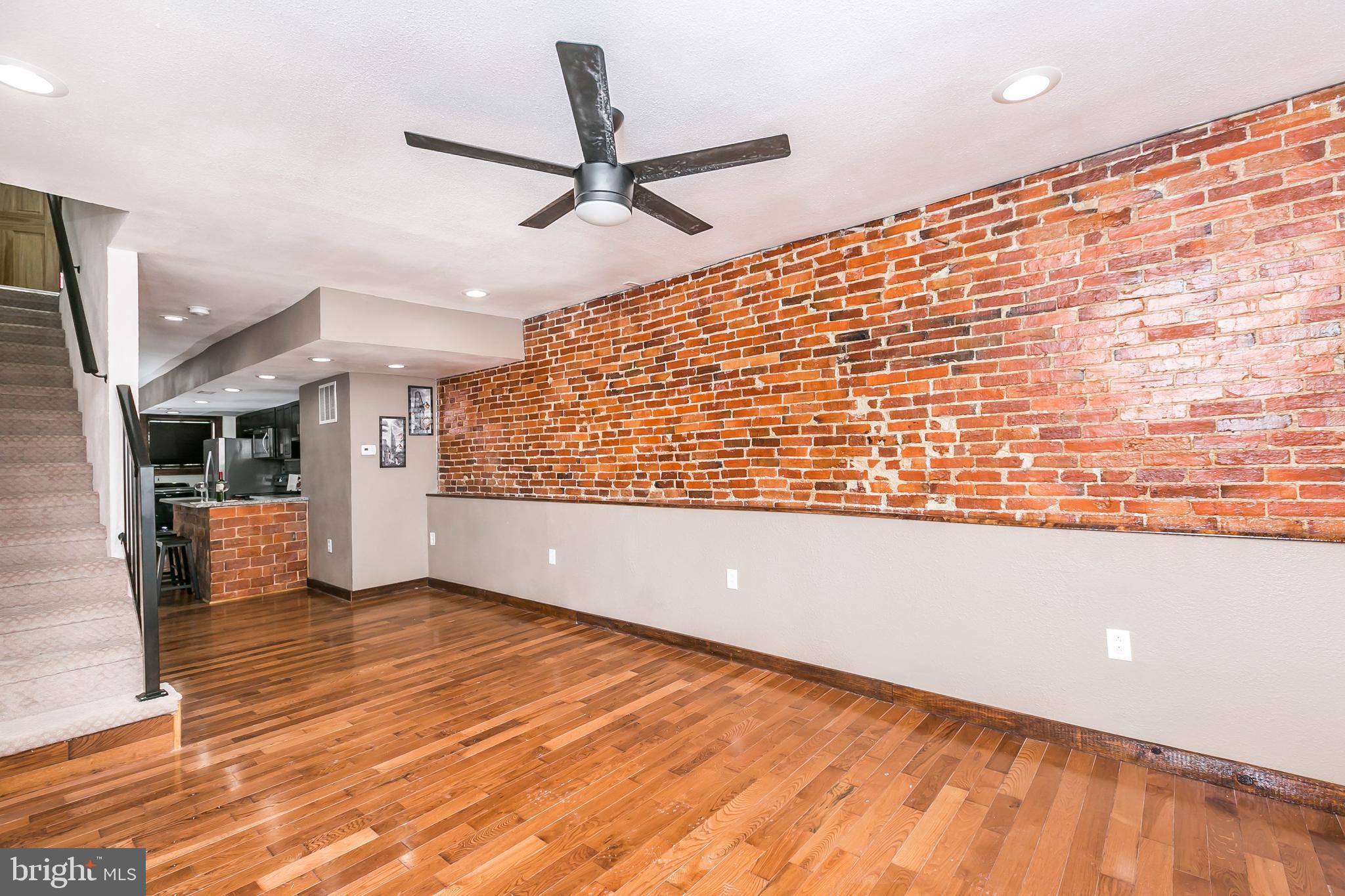 609 Wyeth Street Baltimore, MD 21230 - Photo 2 of 32 a view of an empty room with wooden floor and a window