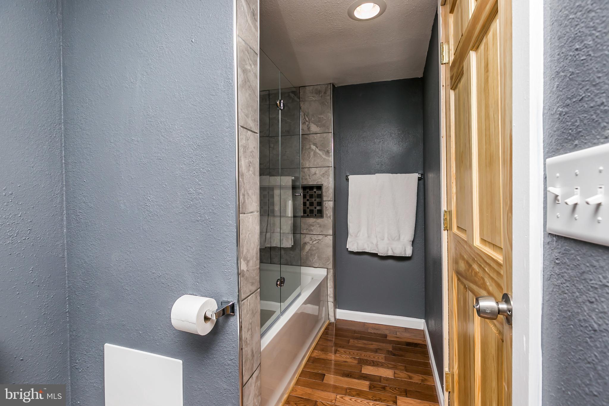 609 Wyeth Street Baltimore, MD 21230 - Photo 19 of 32 a bathroom with a bathtub and shower