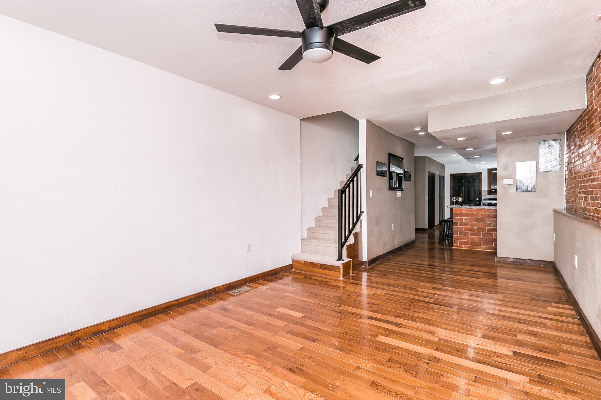 609 Wyeth Street Baltimore, MD 21230 - Photo 3 of 32 a view of a room with wooden floor and stairs
