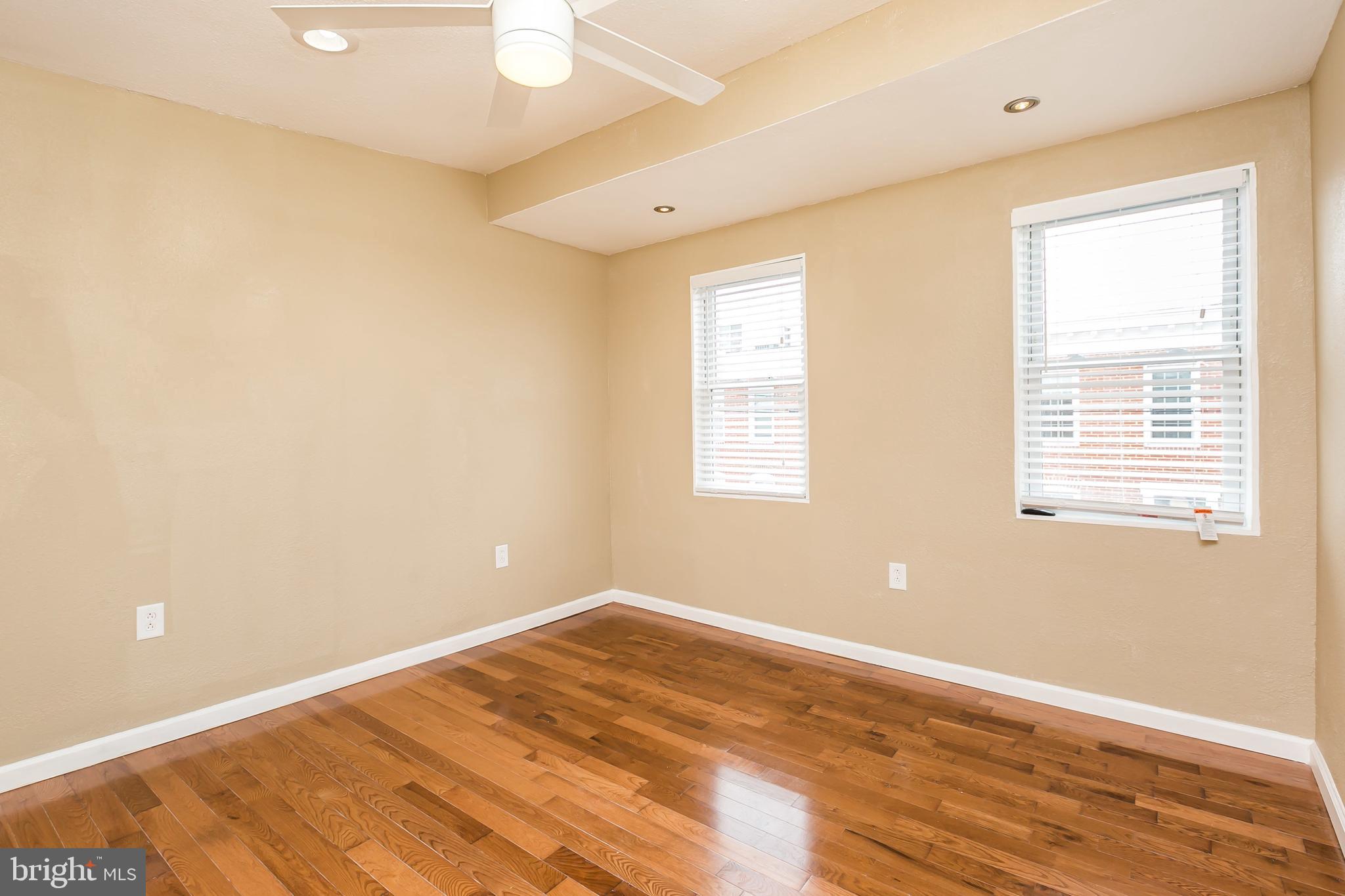 609 Wyeth Street Baltimore, MD 21230 - Photo 23 of 32 a view of empty room with wooden floor and fan