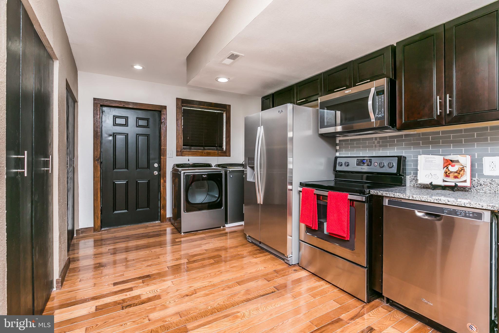 609 Wyeth Street Baltimore, MD 21230 - Photo 7 of 32 a kitchen with stainless steel appliances granite countertop a refrigerator and a stove top oven