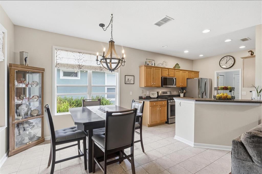207 Coleton Lane DeLand, FL 32724 - Photo 13 of 65 a view of a dining room with furniture large window and wooden floor