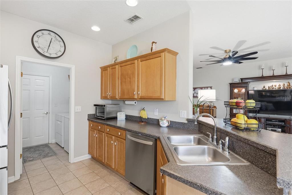 207 Coleton Lane DeLand, FL 32724 - Photo 19 of 65 a kitchen with stainless steel appliances granite countertop a sink stove and cabinets