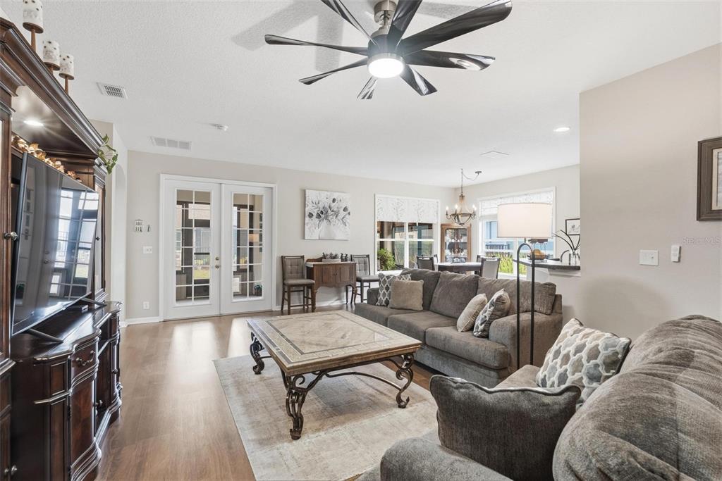 207 Coleton Lane DeLand, FL 32724 - Photo 3 of 65 a living room with furniture a ceiling fan and a flat screen tv