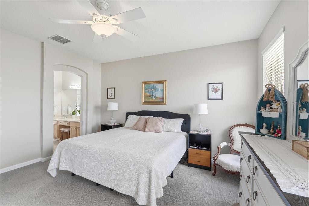 207 Coleton Lane DeLand, FL 32724 - Photo 36 of 65 a bedroom with a bed and a chandelier