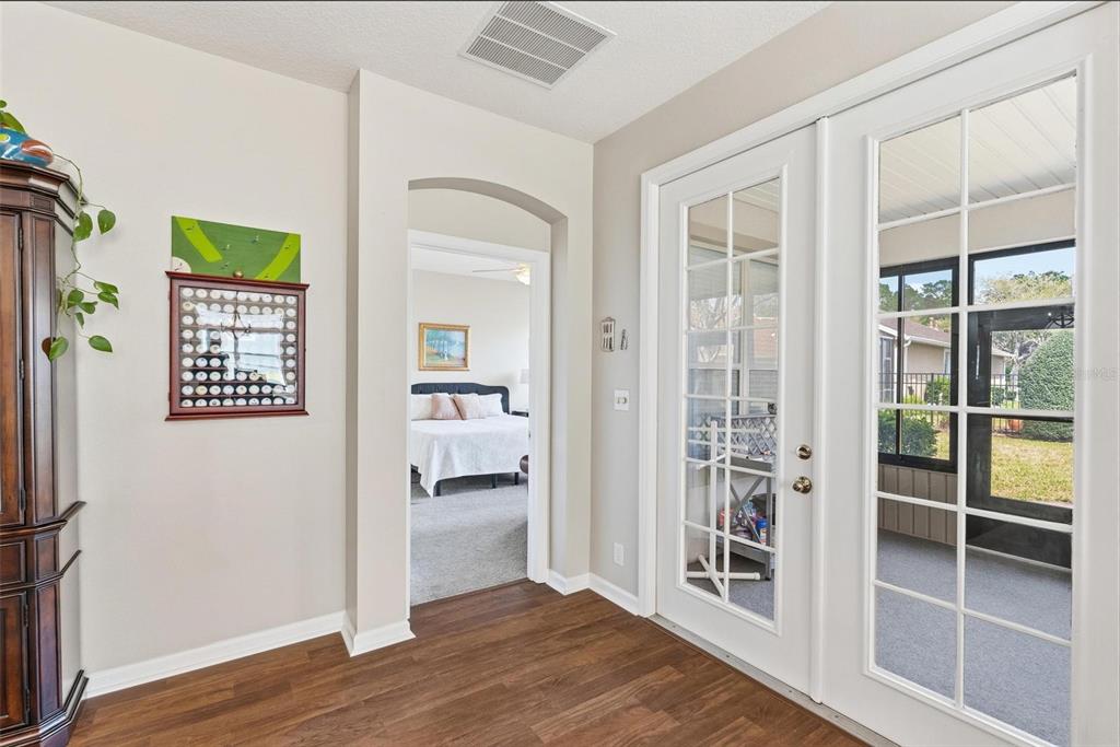207 Coleton Lane DeLand, FL 32724 - Photo 40 of 65 a view of a hallway with wooden floor and a bedroom
