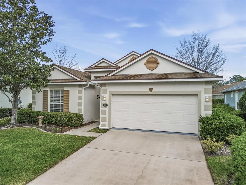207 Coleton Lane DeLand, FL 32724 - Photo 49 of 65 a front view of a house with a garden and plants