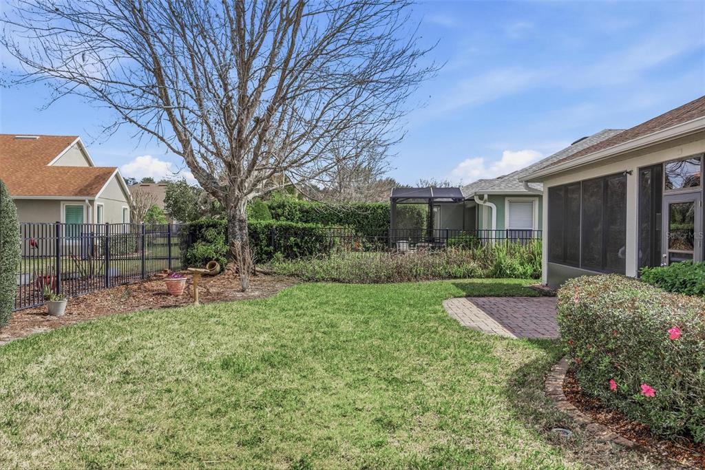 207 Coleton Lane DeLand, FL 32724 - Photo 52 of 65 a view of a chair and table in backyard of the house