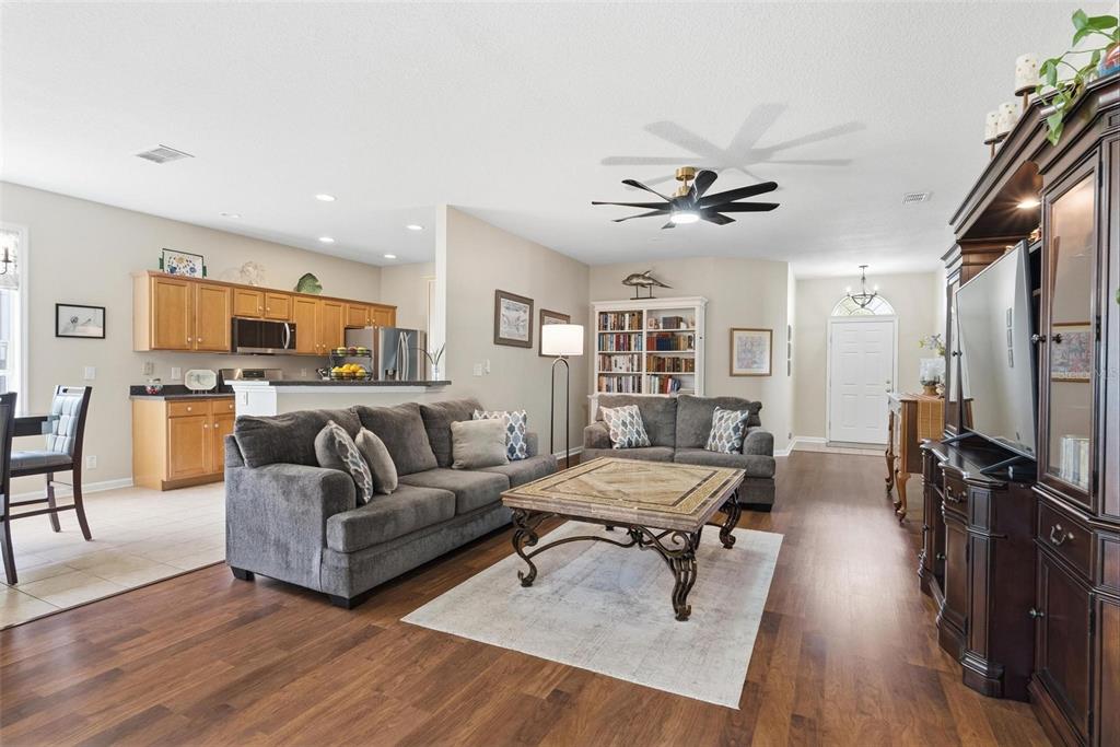 207 Coleton Lane DeLand, FL 32724 - Photo 8 of 65 a living room with furniture flat screen tv and wooden floor