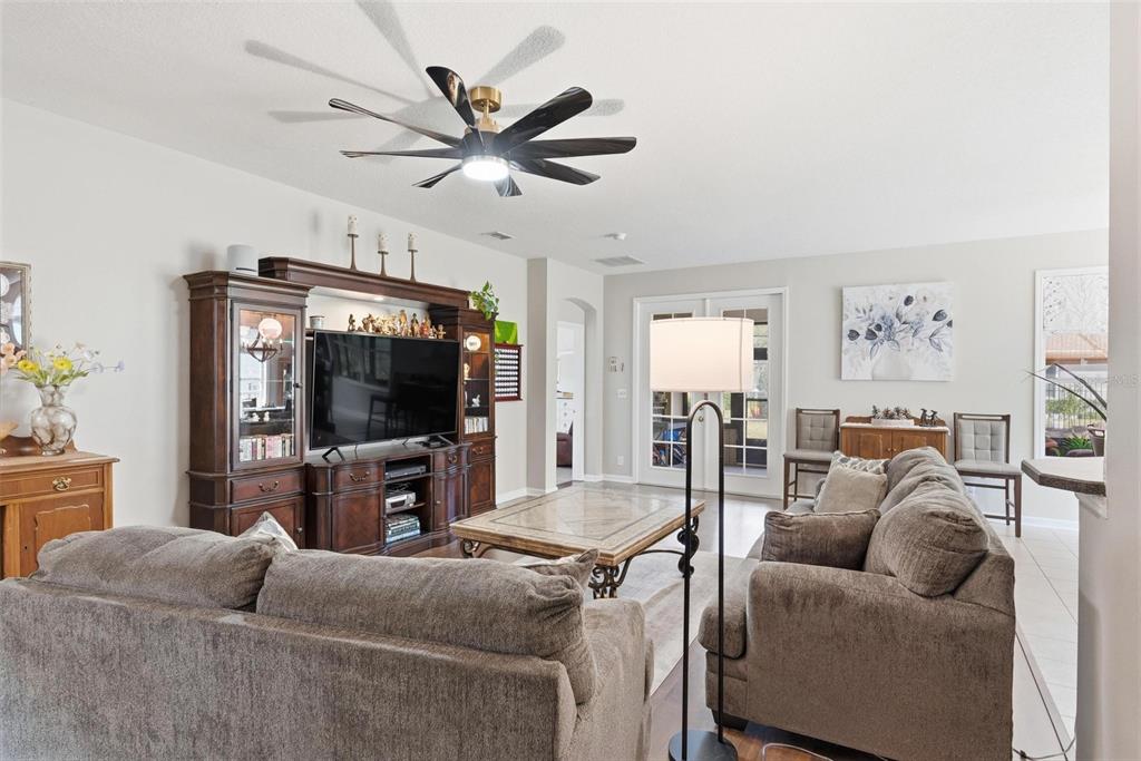 207 Coleton Lane DeLand, FL 32724 - Photo 10 of 65 a living room with furniture and a flat screen tv