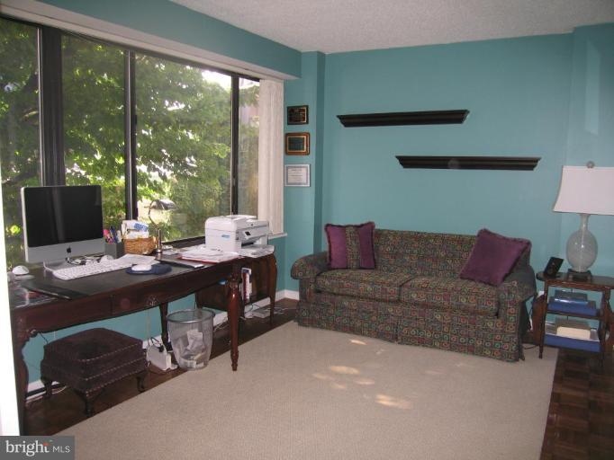 1077 30th Street Northwest, Unit 304 Washington, DC 20007 - Photo 2 of 27 a living room with furniture and a window