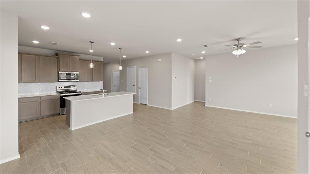 348 Deer Rdg Drive Aledo, TX 76008 - Photo 11 of 15 a view of kitchen with kitchen island stainless steel appliances cabinets a sink and a counter top space