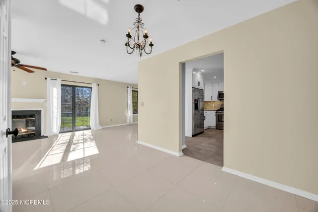 en empty room with fireplace and windows