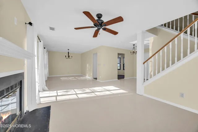 a view of a livingroom with a ceiling fan and window
