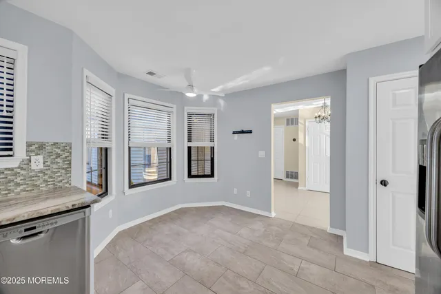 a view of a kitchen with granite countertop cabinets and refrigerator
