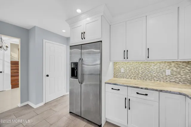 a kitchen with granite countertop a stove a sink a granite counter tops and a window