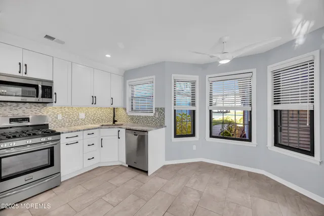 a bathroom with a granite countertop sink toilet and a mirror