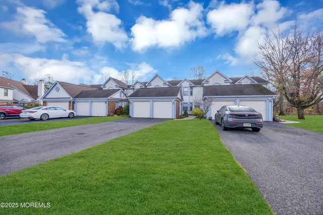a car parked in front of a house with a yard