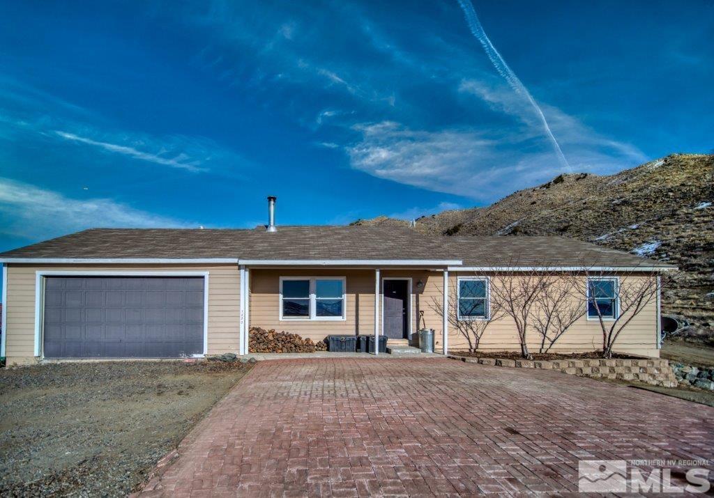 1230 Bullion Hill Road Reno, NV 89508 - Photo 1 of 26 a front view of a house with a yard and garage