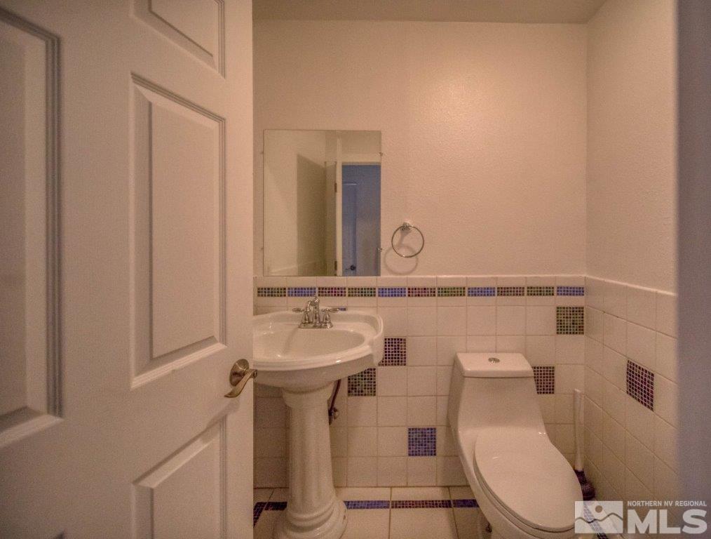 1230 Bullion Hill Road Reno, NV 89508 - Photo 9 of 26 a bathroom with a toilet sink and mirror
