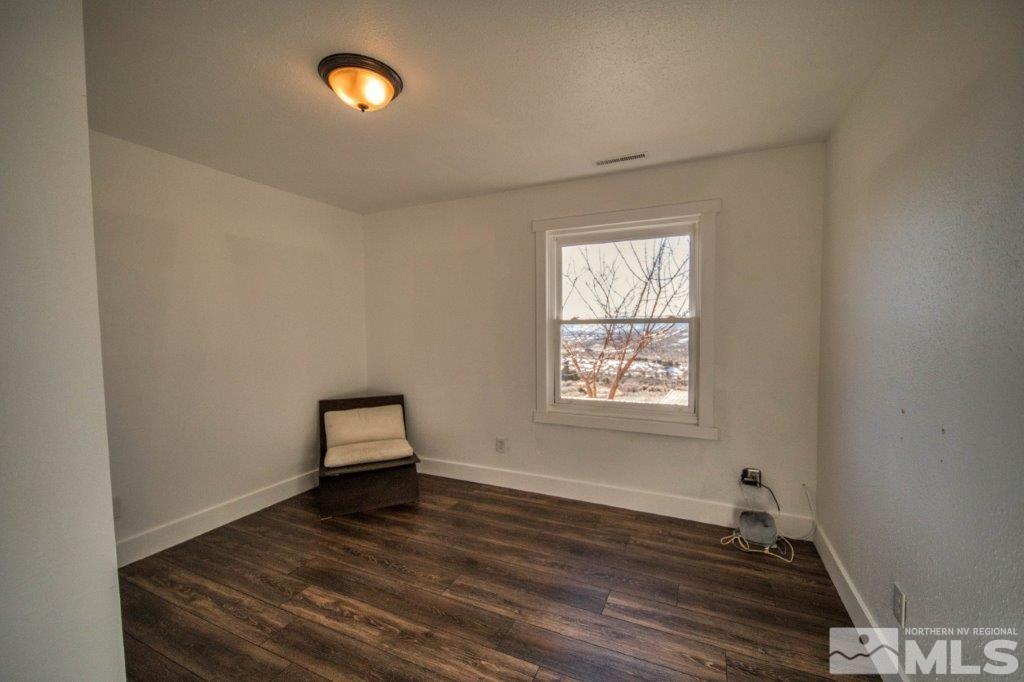 1230 Bullion Hill Road Reno, NV 89508 - Photo 10 of 26 wooden floor in an empty room with a window