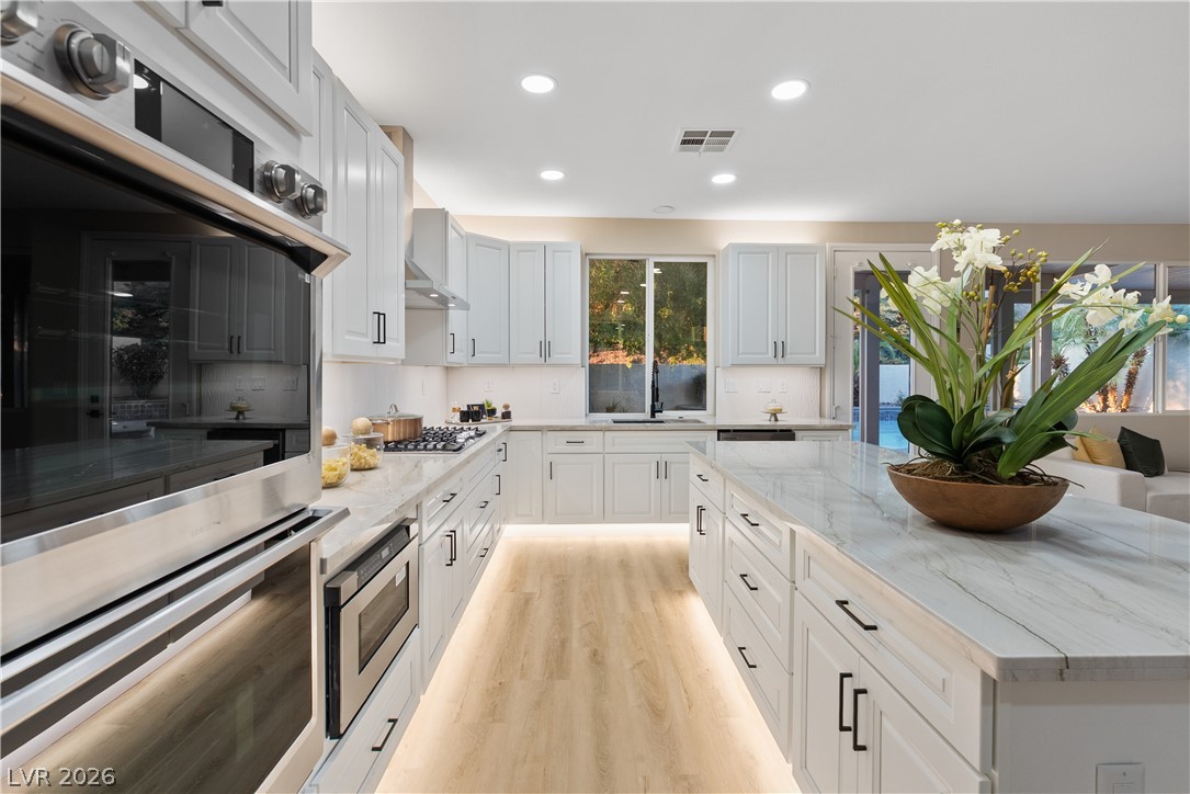 1662 Ravanusa Drive Henderson, NV 89052 - Photo 58 of 74 Culinary delights await in this bright kitchen with a spacious island and modern amenities.
