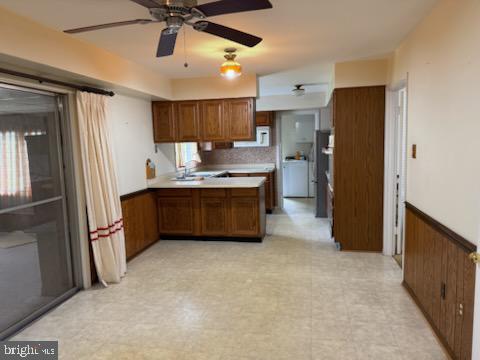 12206 Maycheck Lane Bowie, MD 20715 - Photo 15 of 19 a kitchen with stainless steel appliances a sink cabinets and a refrigerator