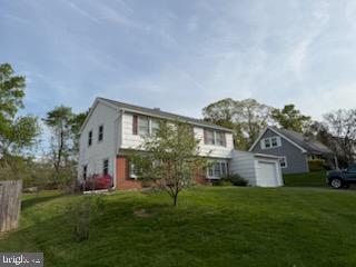12206 Maycheck Lane Bowie, MD 20715 - Photo 2 of 19 a front view of a house with a yard and garage